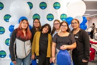 Bronx parents take a photo in front of UFT’s BRAVE sign. BRAVE is the UFT's anti-bullying initiative.