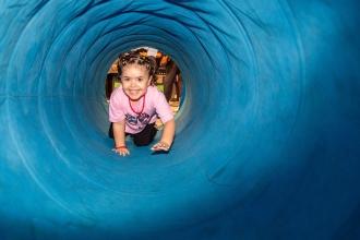 A child is all smiles while going through part of an obstacle course during the UFT Bronx KidZone and Community Resource Fair.