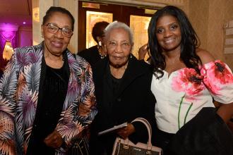 Three women pose for a photo