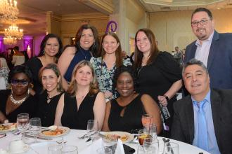 A group of staff members pose together at a table