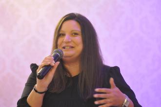 A women speaks into a microphone