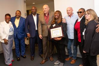 A group of members pose for a photo with the union president 