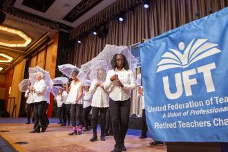 A group of tap dancers perform on stage 