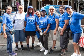 A group of UFT members take a photo on the sidewalk