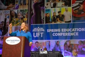 A woman speaks at the podium