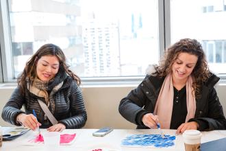 Two attendees at the 2024 UFT Early Childhood Conference take part in a workshop. 