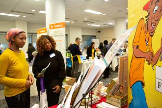 Two women look at a display
