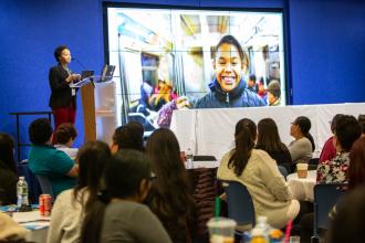 A woman addresses a crowd at a conference