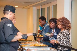 Attendees at the 2024 School Nurses Appreciation Dinner line up for dinner. 