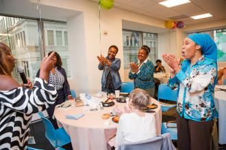 School nurses in attendance at the 2024 UFT School Nurses Appreciation Dinner give a round of applause as chapter leader Cynthia Bennett speaks. 