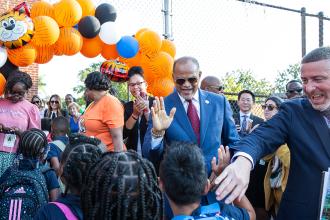 A man gives a high five to a student 