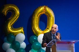 Misha Thomas at the podium during his keynote address.