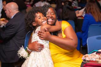 Yahia Williams is hugged by her daughter at the 2024 Provider Awards Celebration at UFT Headquarters on May 10, 2024. 