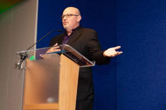 A man speaks at the podium during an awards ceremony