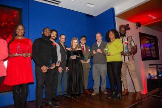 A group of honorees line up to receive their awards. 