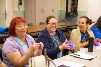 Teachers smile while taking part in a multisensory workshop during a day of wellness for educators on September 14, 2024. 