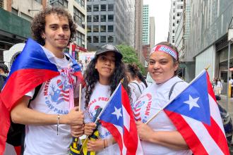 A woman on the right poses for a photo with her children. 