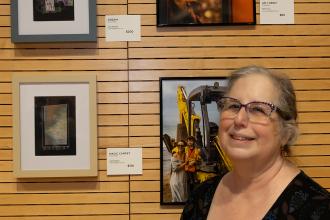 Lisa Kaplan takes a photo in front of her art pieces at the New York City Art Teachers Association/UFT’s Dreams Art Show on May 10, 2024. 