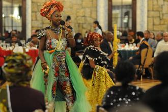 A woman speaks on the mic during live entertainment