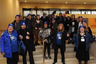 A large group of UFT members pose for a photo with union president Michael Mulgrew