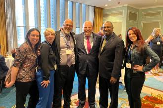 Marsh/Raimo awardee Chris Alena (third from left), the chapter leader at Curtis HS in Staten Island, enjoys the reception that followed Teacher Union Day with Mulgrew (fourth from left) and Staten Island supporters.