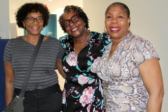 Three women pose for a photo