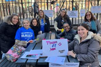 A group of teachers gather in a park for a day of action demonstration