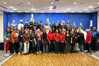 Volunteers take a group photo at the UFT/Coalition for the Homeless holiday toy drive and celebration on Dec. 7, 2024. 