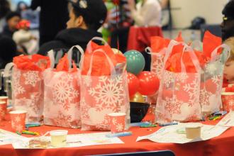 Gift bags filled with stocking-stuffer treats, such as plush toys, socks and toy cars, greet students arriving to the UFT/Coalition for the Homeless holiday toy drive and celebration on Dec. 7, 2024. 