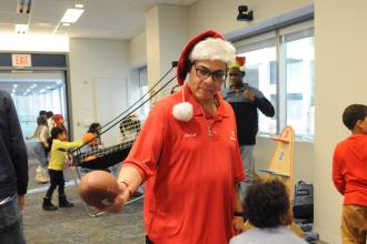 A volunteer assists with the football target station at the UFT/Coalition for the Homeless holiday toy drive on Dec. 7, 2024. 
