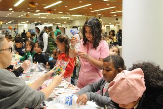 Students are assisted in their crafts at the UFT Middle School Division’s annual Thanksgiving Luncheon on Nov. 23, 2024. 
