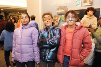 Three students show off their new coats at UFT Middle School Division’s annual Thanksgiving Luncheon on Nov. 23, 2024. 