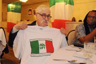 A man shows off his UFT Italian-American heritage committee t-shirt