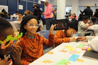 A student shows off her art work