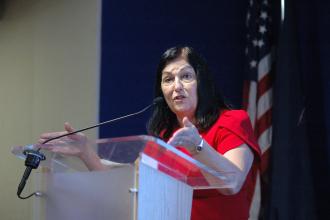 UFT Vice President Anne Goldman speaks at the podium