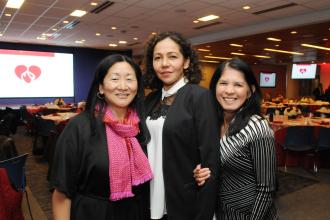 Three women at a nurses celebration pose for a photo