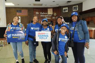 Paraprofessionals take a group photo at the union hall in Philadelphia before spending the morning door-knocking for Kamala Harris and Tim Walz.