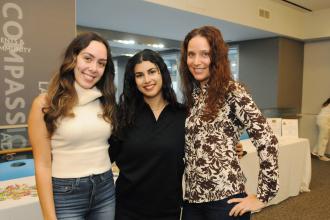 Three psychologists in attendance at the UFT's Psychologist Appreciation Day held at UFT headquarters smile for a group photo. 