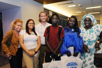 A group of award winners pose for a photo with teachers and families 