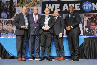 Backer/Sheintaub Award winners pose for a photo on the stage with union officials at the Midtown Hilton during Teacher Union Day on Nov. 3, 2024.