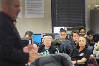 Teachers look on as Mulgrew speaks