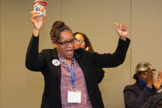 A woman celebrates after winning a raffle prize
