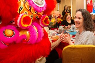 Maggie Joyce, the chapter leader at PS 35 in the Bronx, gets into the spirit of the traditional lion dance at the banquet.