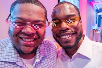Community Champion Award honoree Quwan Pearsall (right), a paraprofessional from HS for Public Service: Heroes of Tomorrow in Brooklyn, celebrates with his husband at the UFT Academic High School Awards on April 25, 2025. 