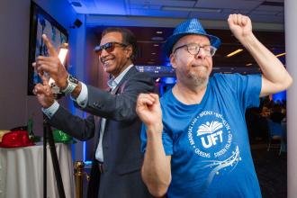 Two UFT members at the 2026 Academic High Schools Awards take a celebratory dance break. 