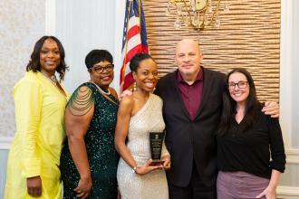 Guests and award winners at the UFT African Heritage Committee Dinner Dance take a photo with UFT President Michael Mulgrew. 