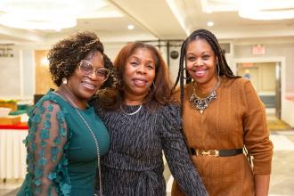 Attendees at the 2025 UFT African Heritage Committee Awards Dinner take a photo with UFT VP for Elementary Schools Karen Alford. 