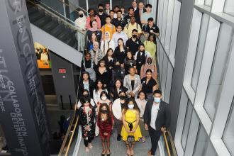 Large group poses on a staircase