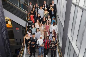 Large group poses on a staircase