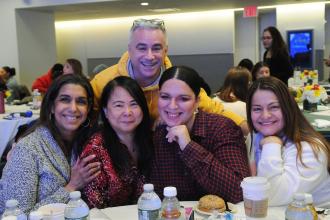 A group of school social workers take a photo at a table during the 2026 UFT Clinician's Appreciation Day